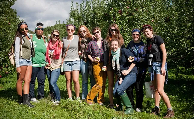 A group of Smithies smiling and posing together at an apple orchard.
