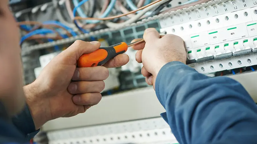 Closeup of an electrician working on an electrical panel